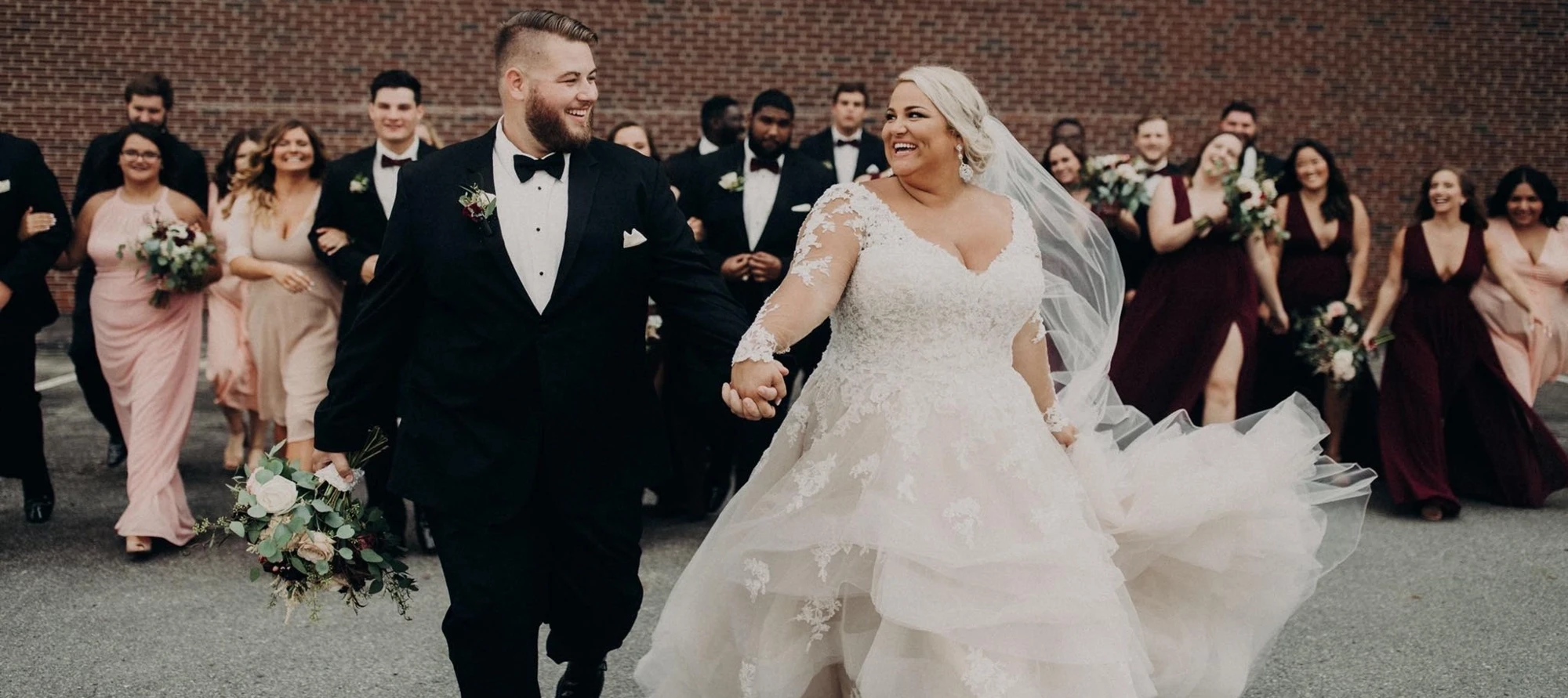 Сouple wearing a white gown and a black suit