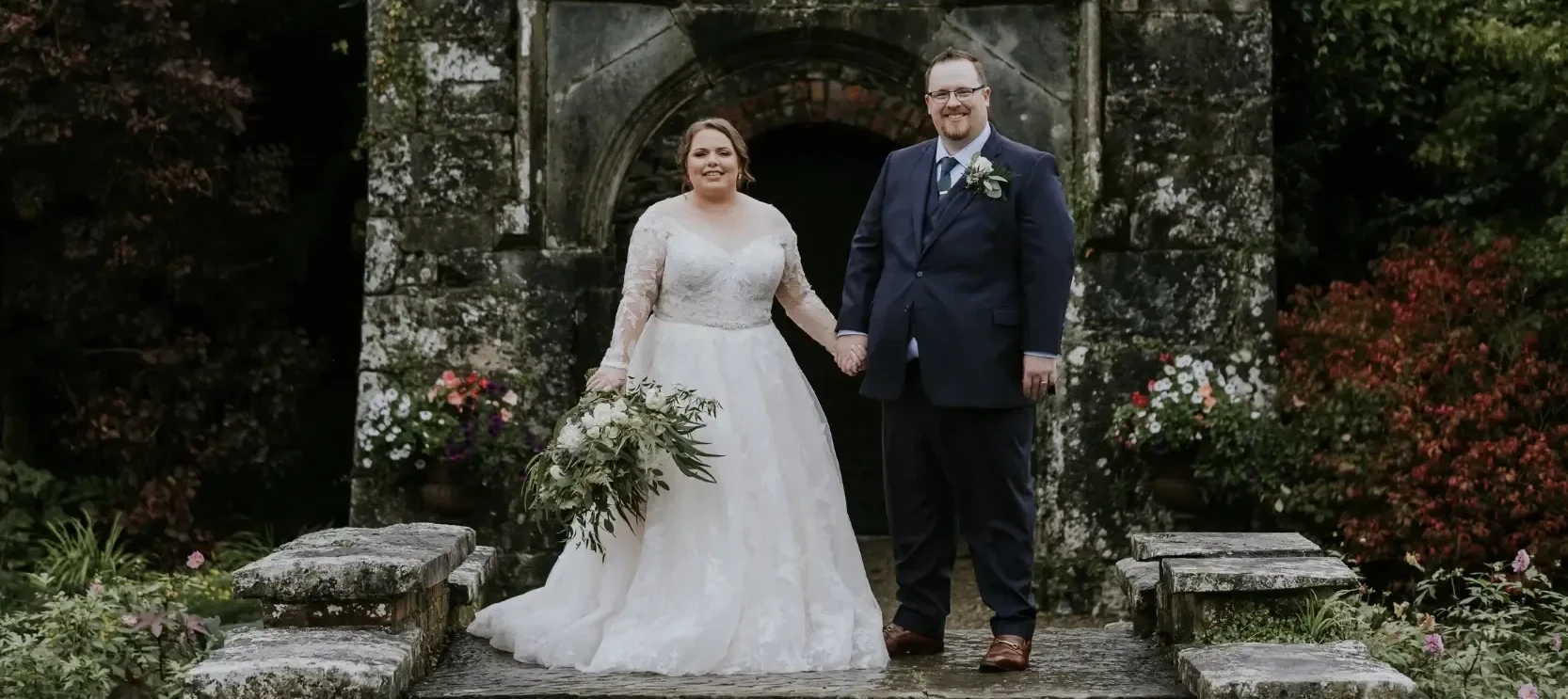 Сouple wearing a white gown and a black suit