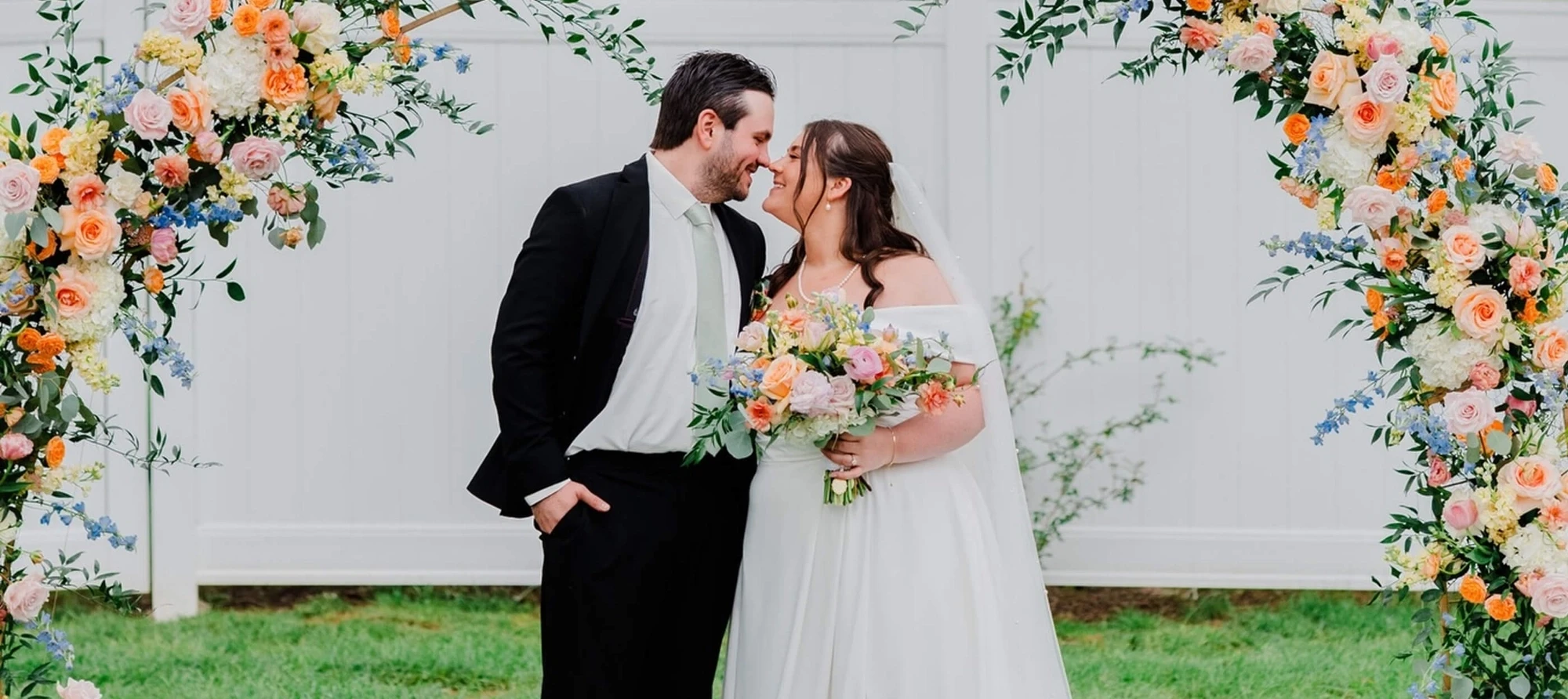 Сouple wearing a white gown and a black suit